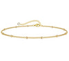 18K gold anklet stack set — 21 layered ankle bracelets including Cuban link, herringbone, tennis, rope, beaded, and leaf chain styles