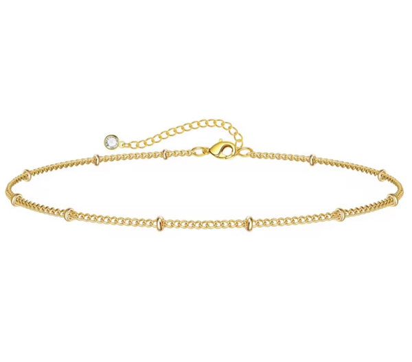 18K gold anklet stack set — 21 layered ankle bracelets including Cuban link, herringbone, tennis, rope, beaded, and leaf chain styles