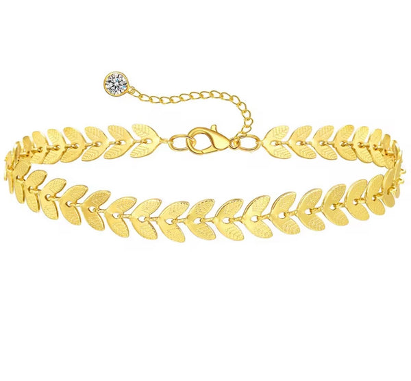18K gold anklet stack set — 21 layered ankle bracelets including Cuban link, herringbone, tennis, rope, beaded, and leaf chain styles