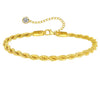 18K gold anklet stack set — 21 layered ankle bracelets including Cuban link, herringbone, tennis, rope, beaded, and leaf chain styles