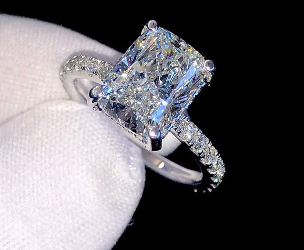 1ct VVS radiant cut moissanite engagement ring in 14K gold PVD-bonded sterling silver pavé setting held in white glove — Twelfth XII