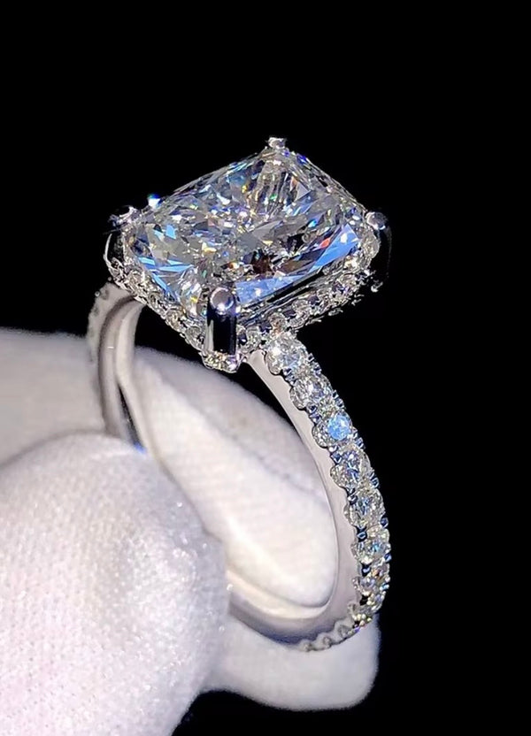 1ct VVS radiant cut moissanite engagement ring in 14K gold PVD-bonded sterling silver pavé setting held in white glove — Twelfth XII