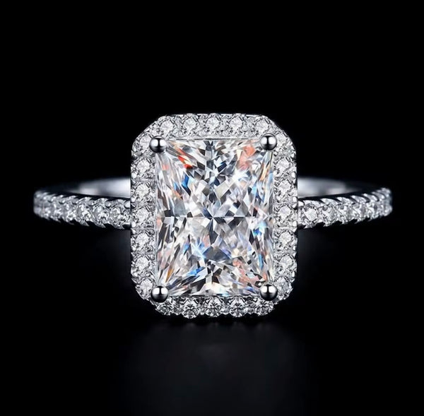 2ct radiant cut moissanite halo engagement ring in S925 sterling silver four-claw pavé setting on dark background — Twelfth XII