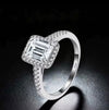 S925 stamped emerald cut moissanite halo ring in sterling silver pavé setting close-up on dark background — Twelfth XII engagement ring