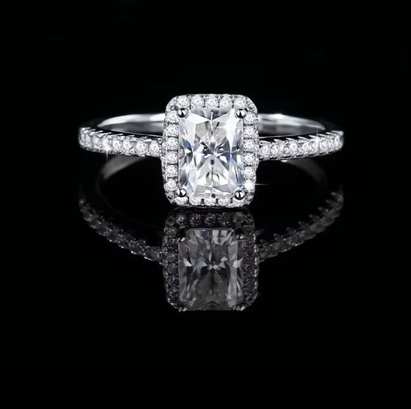 Top-down view of radiant cut moissanite halo ring in S925 sterling silver pavé setting on dark background — Twelfth XII wedding ring