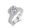 D color VVS1 round moissanite cushion halo split shank engagement ring with matching pavé wedding band in S925 sterling silver on white background — Twelfth XII 2-in-1 bridal set