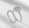 D color VVS1 round moissanite cushion halo split shank engagement ring with matching pavé wedding band in S925 sterling silver on white background — Twelfth XII 2-in-1 bridal set