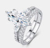 Marquise cut moissanite bridal ring set in sterling silver — angled studio view showing three-stone setting and split shank pavé wedding band