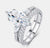 Marquise cut moissanite bridal ring set in sterling silver — angled studio view showing three-stone setting and split shank pavé wedding band
