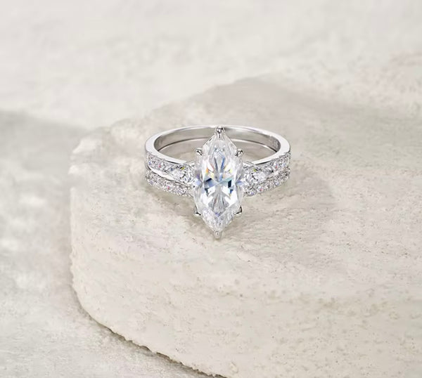 Front view of marquise moissanite engagement ring with pear side stones and round pavé accents — S925 sterling silver bridal set