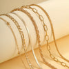 6 piece 14K gold stacked anklet set displayed on ankle — snake, figaro, paperclip, box, rope, and satellite chain styles