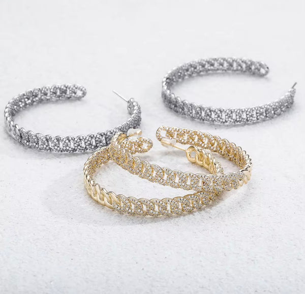 Three iced Cuban link hoop earrings in gold and silver colorways on white background — Twelfth XII luxury jewelry