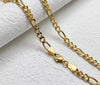 2.5mm 18K solid gold Figaro chain necklace with lobster clasp detail shown on white marble surface