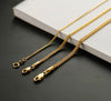 Three solid 18k gold foxtail chain necklaces in 1.3mm, 2mm, and 2.7mm draped over a marble block