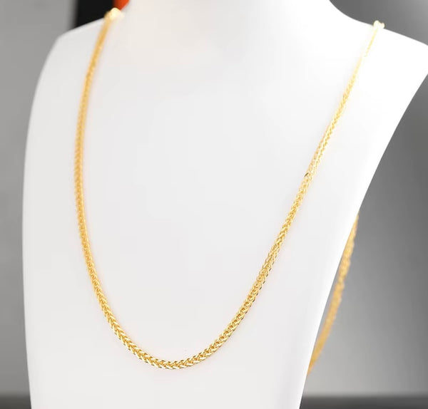 Solid 18k gold foxtail necklace worn on a display bust, close-up of the woven link